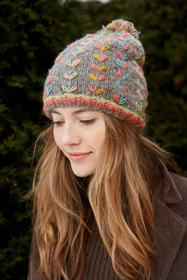 multicolour pachamama beanie with a pom pom on top