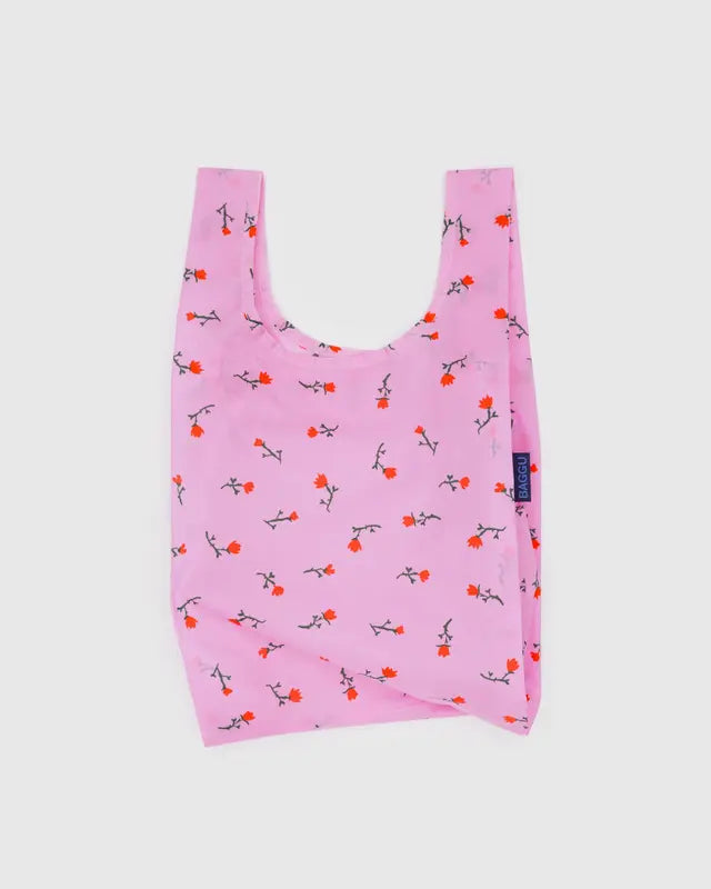 Pink reusable bag with floral pattern on a white background