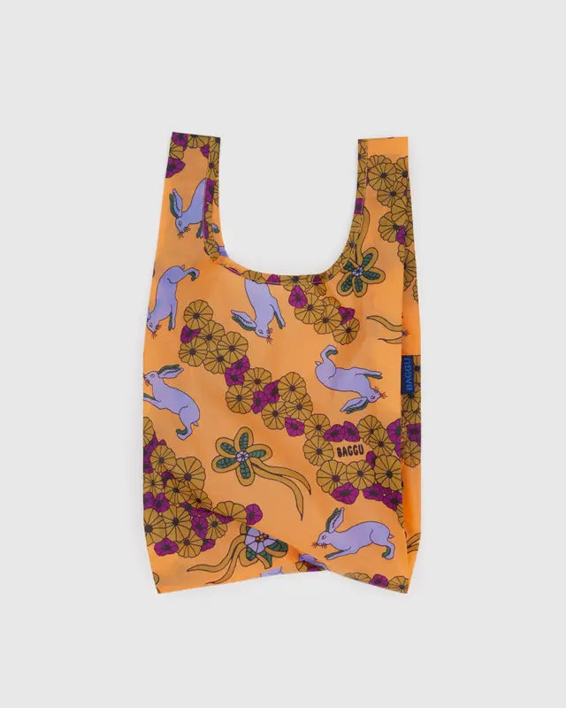 Reusable shopping bag with rabbit and floral pattern on an orange background