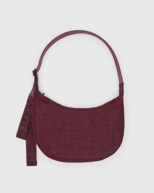 Maroon nylon crossbody bag with a strap on a light gray background
