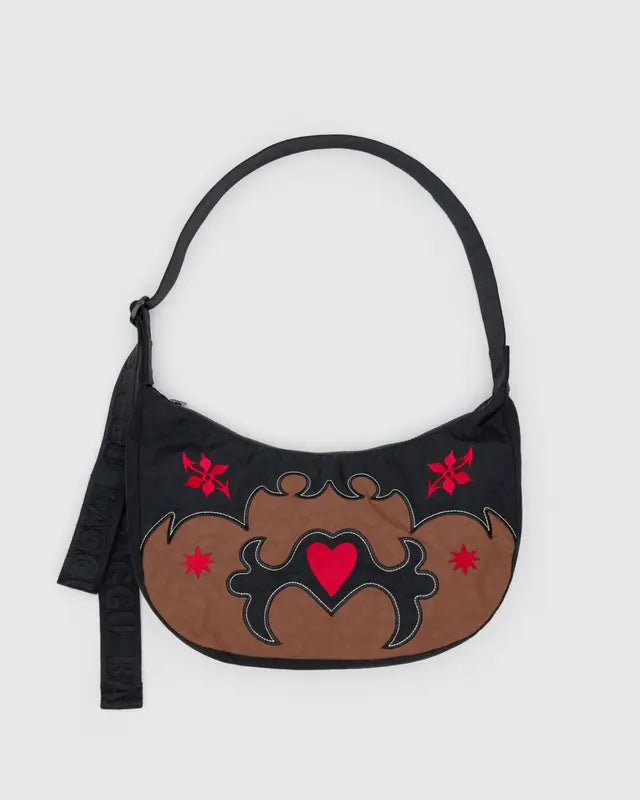 Handbag with decorative western applique design on a white background