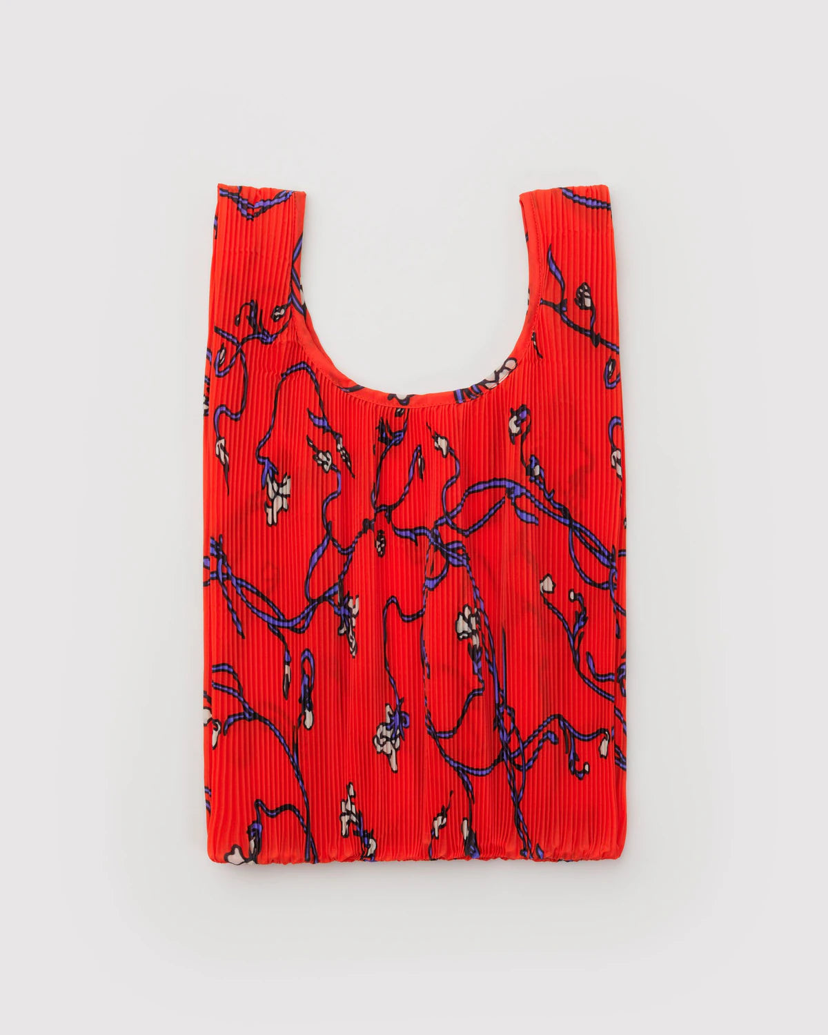 Red pleated bag with black floral pattern on a light gray background