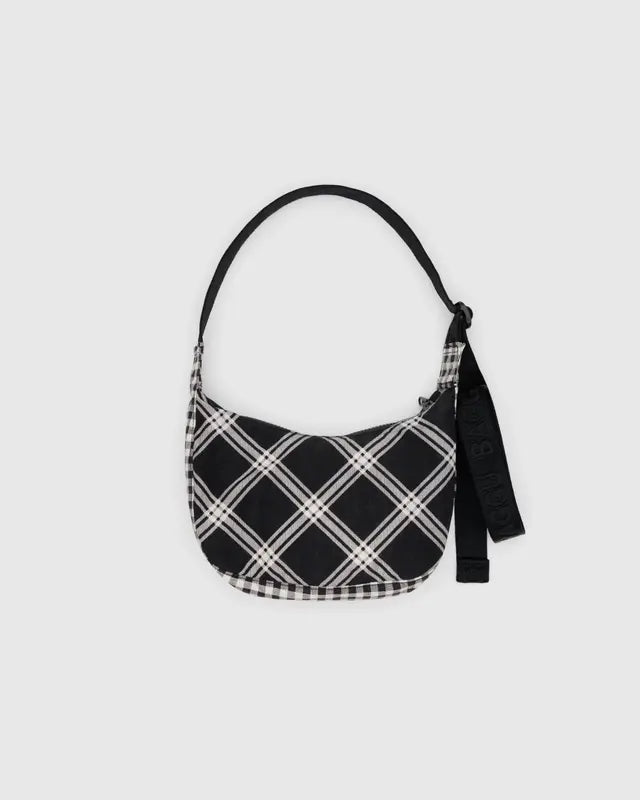 Black and white plaid shoulder bag on a light gray background
