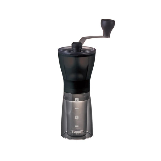 Black and silver manual coffee grinder on a white background