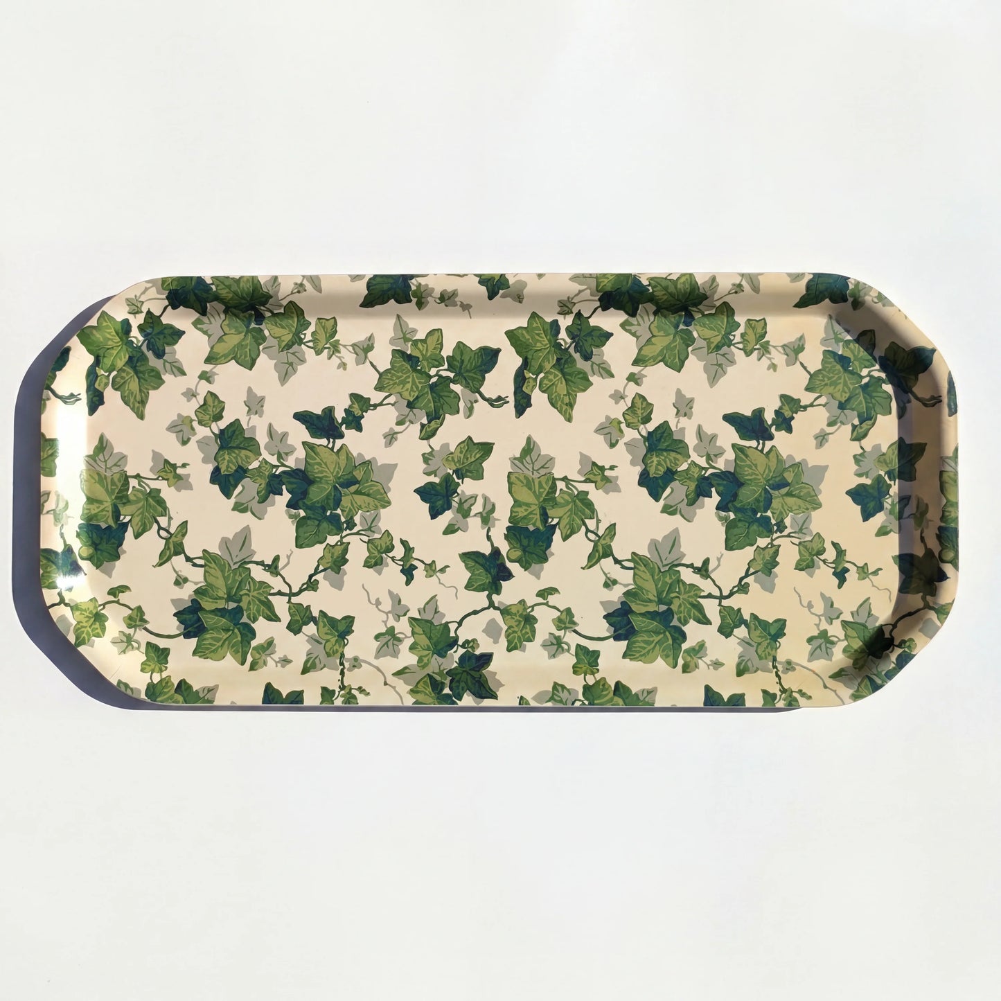 Rectangular tray with green ivy leaf pattern on a beige background