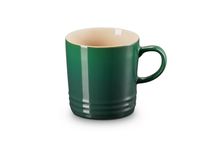 A green ombre mug with a handle and a beige interior