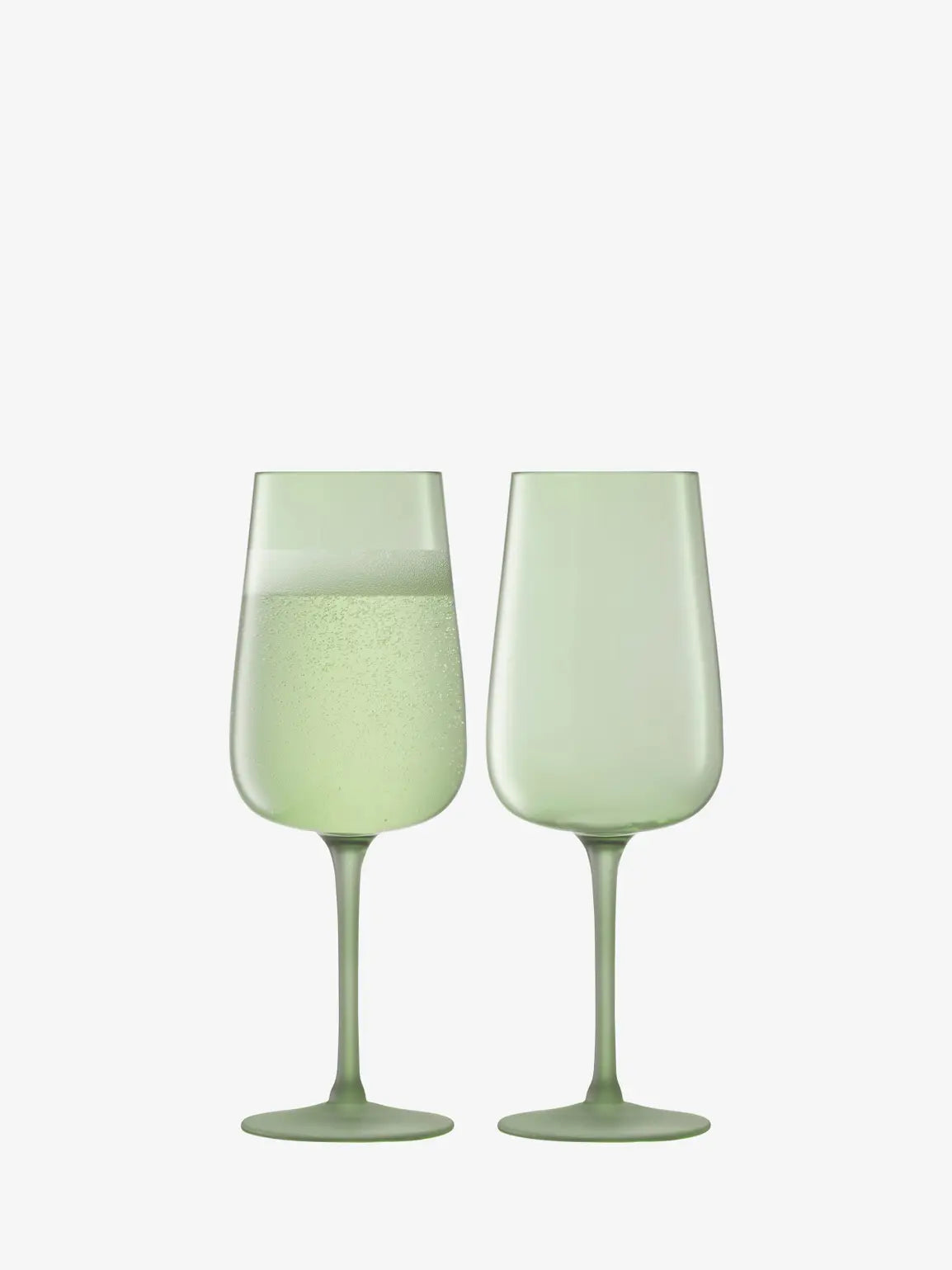 Two light green flute glasses on a white background