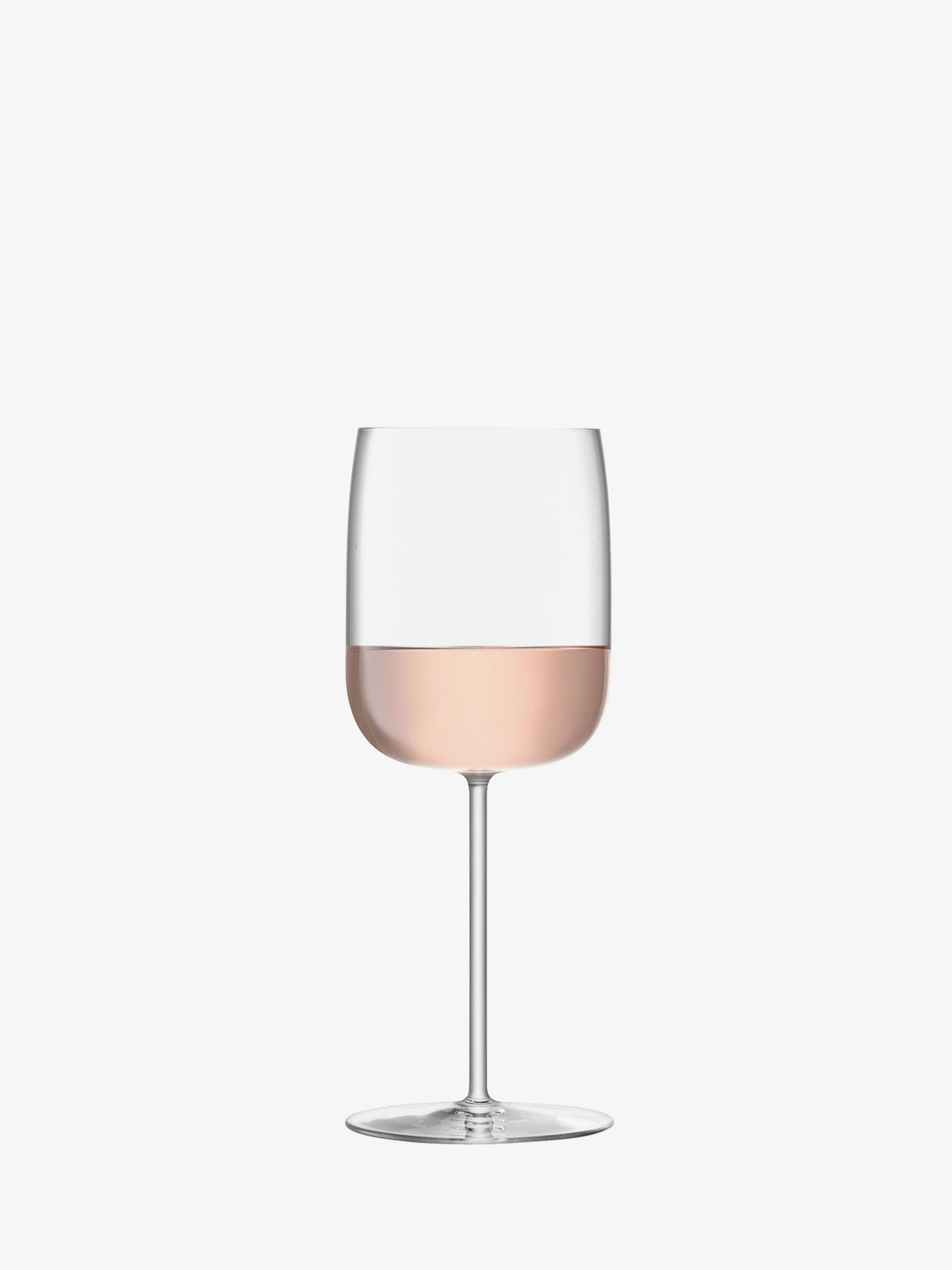 Wine glass with pink wine on a white background