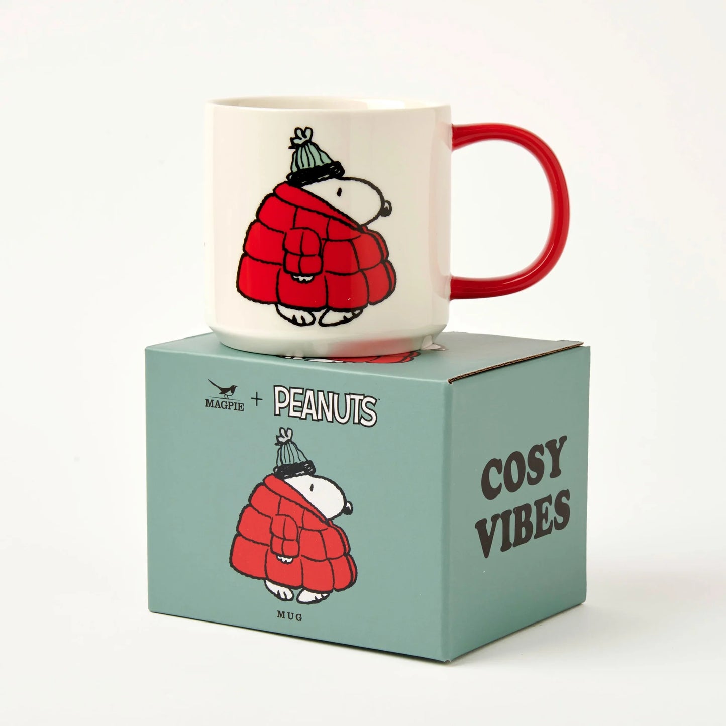 Mug with cartoon character in a red coat on a matching box labeled 'Cosy Vibes'.