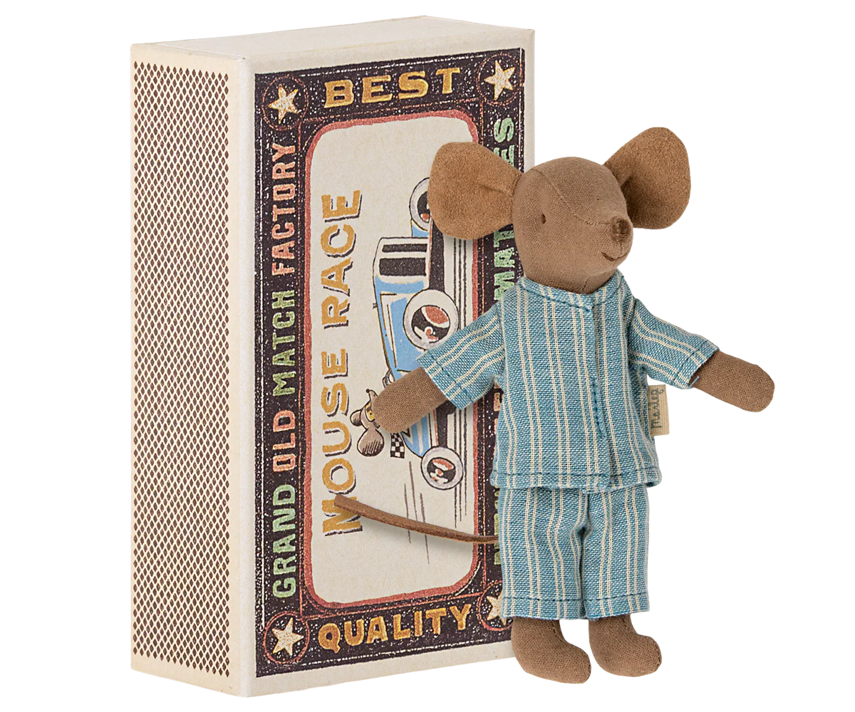 Toy mouse in pajamas standing next to a matchbox with racing design