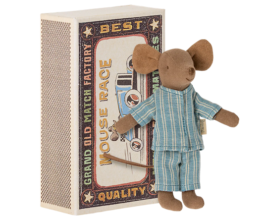 Toy mouse in pajamas standing next to a matchbox with racing design
