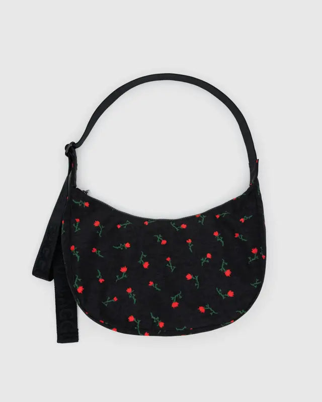 Black handbag with red floral pattern on a light gray background