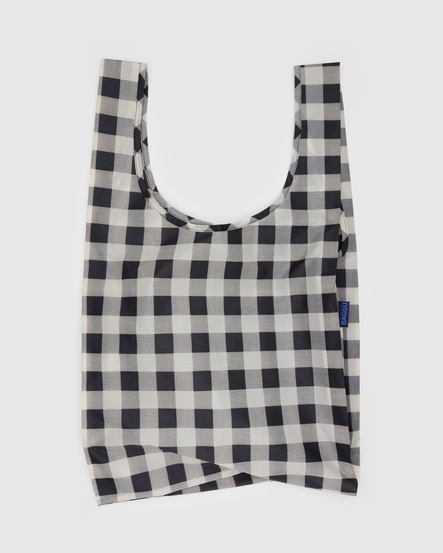 Black and white checkered reusable bag on a light gray background