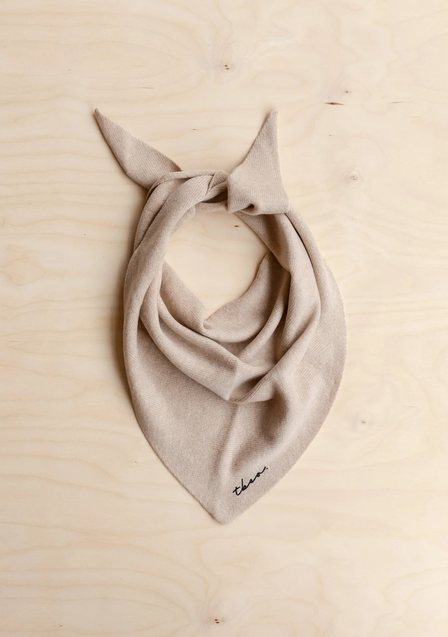 Beige scarf with a bow on a beige background
