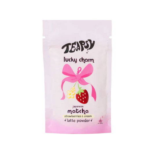 Tea bag packaging with a pink bow and strawberry illustration on a white background