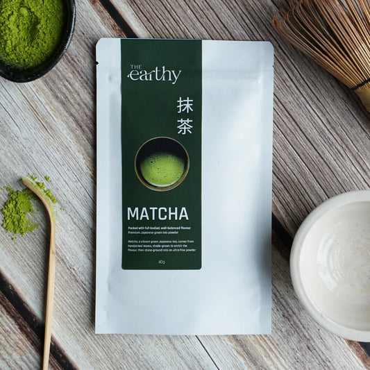 The Earthy Matcha Powder 40g in a white pouch with green detailing.