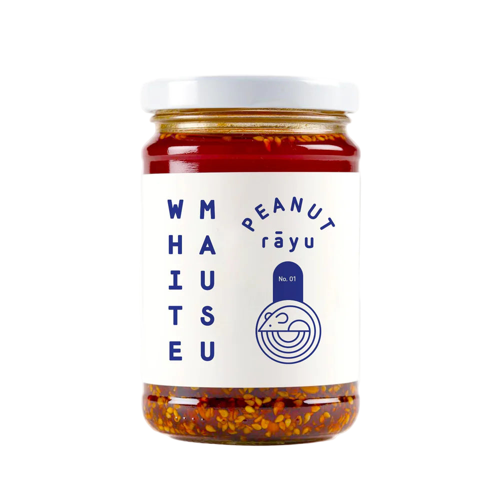 Jar of peanut rayu with a white label on a white background