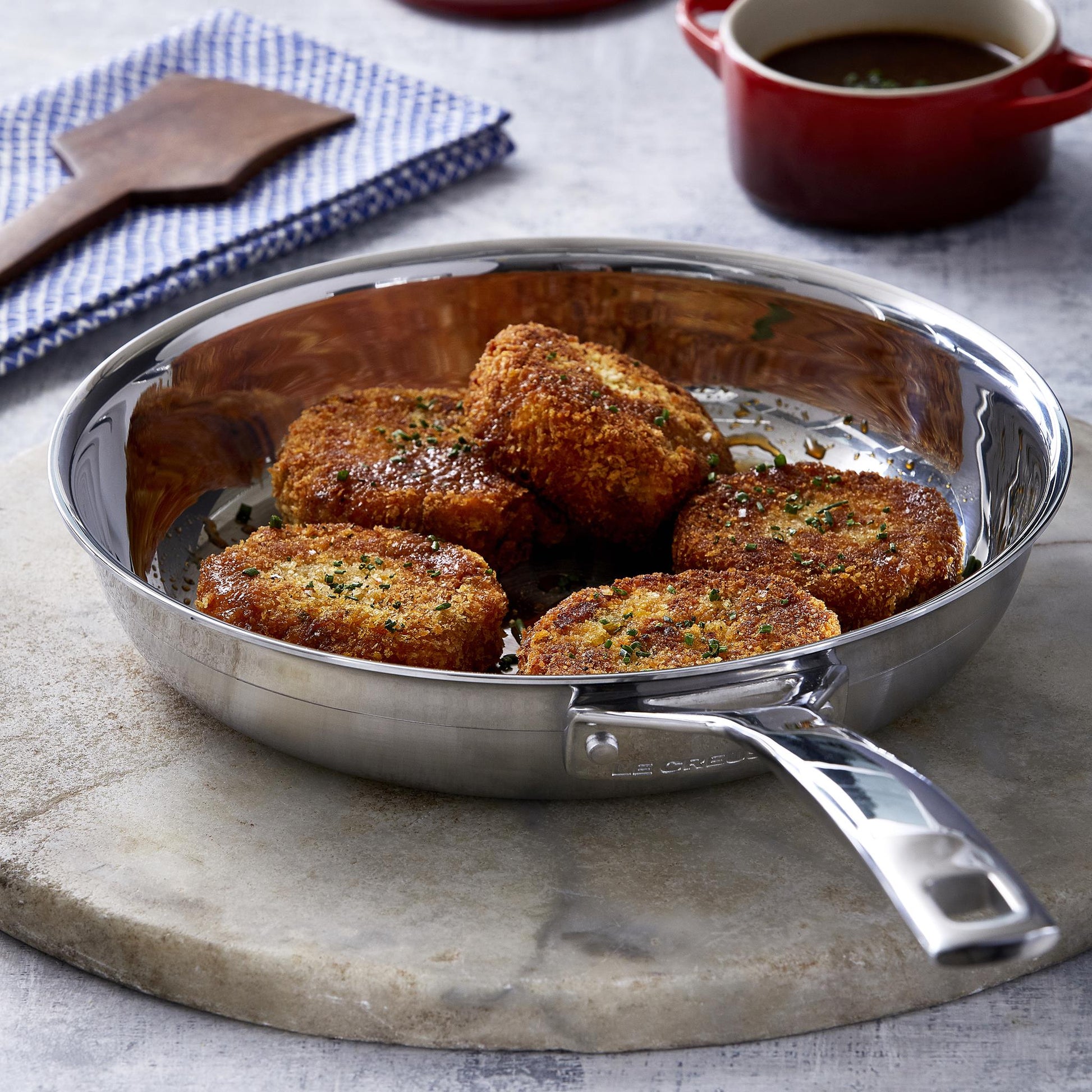 The pan displayed on a dining table serving up croquettes