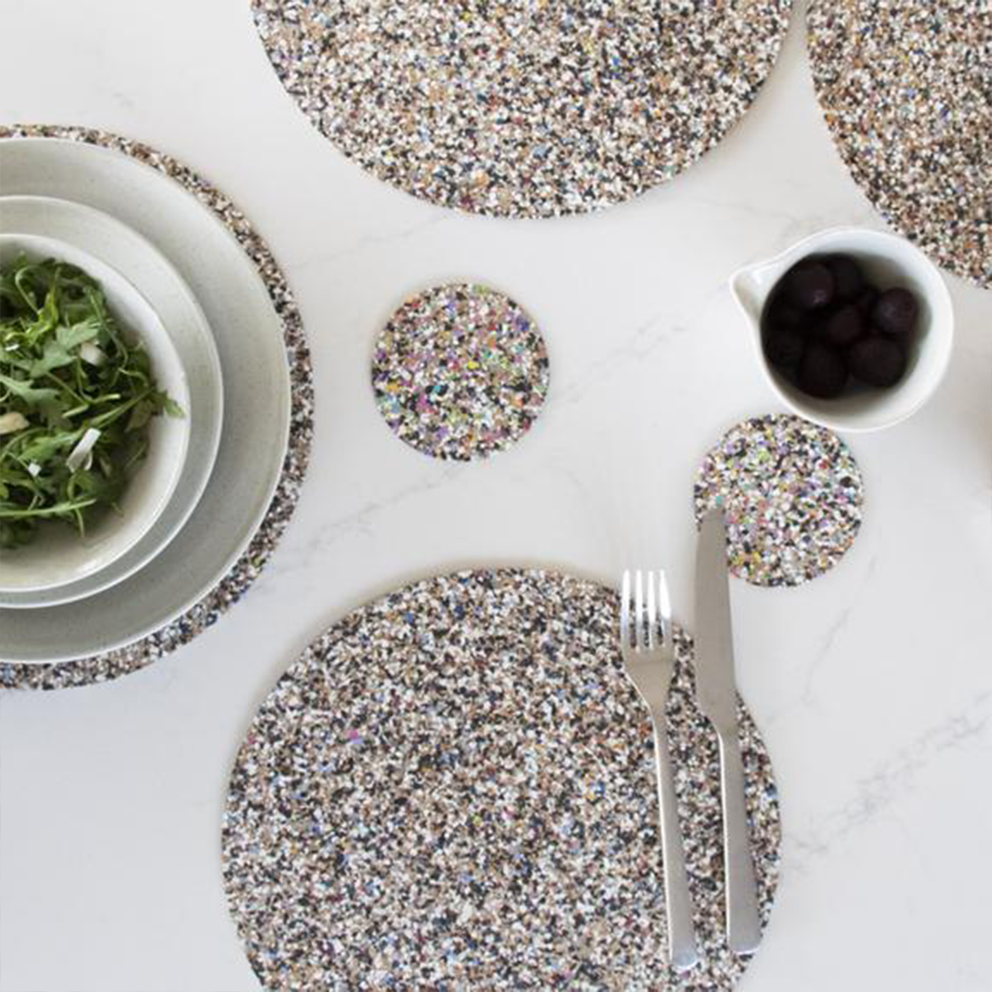 the coasters on a dining table with their matching placemats