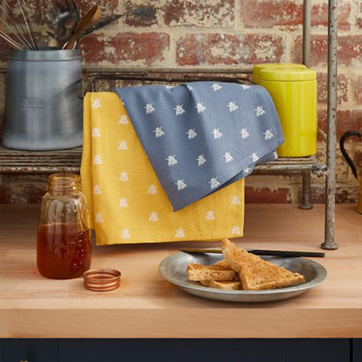 the tea towels in a kitchen with some toast and honey