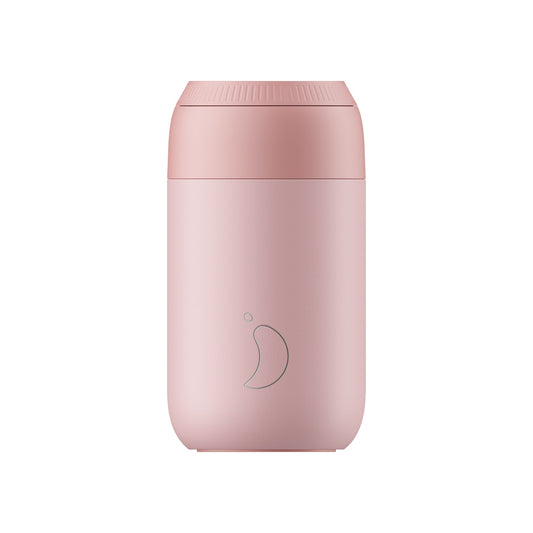 a light pink travel mug with a leak proof rotating lid