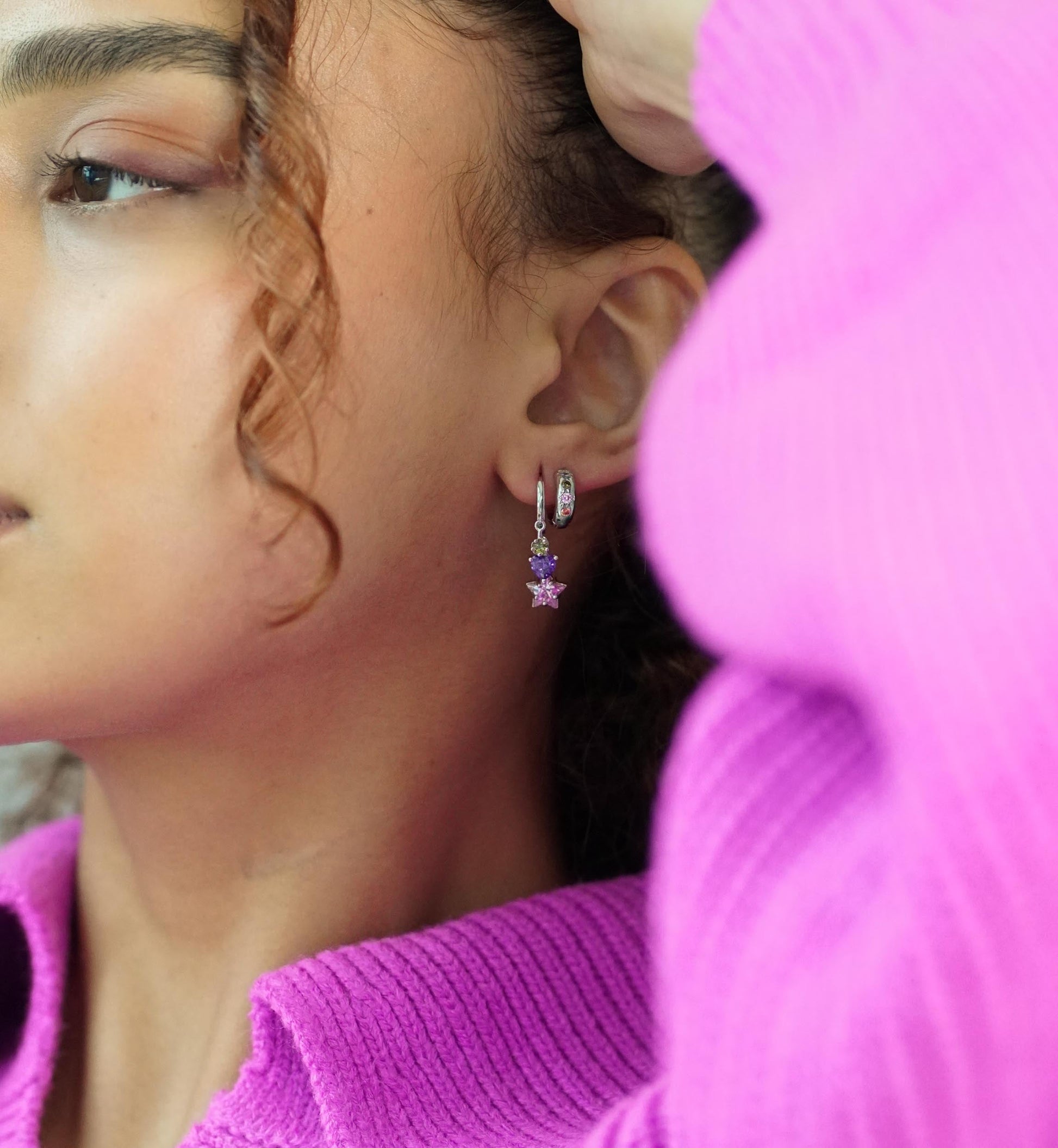 close up of model wearing earrings