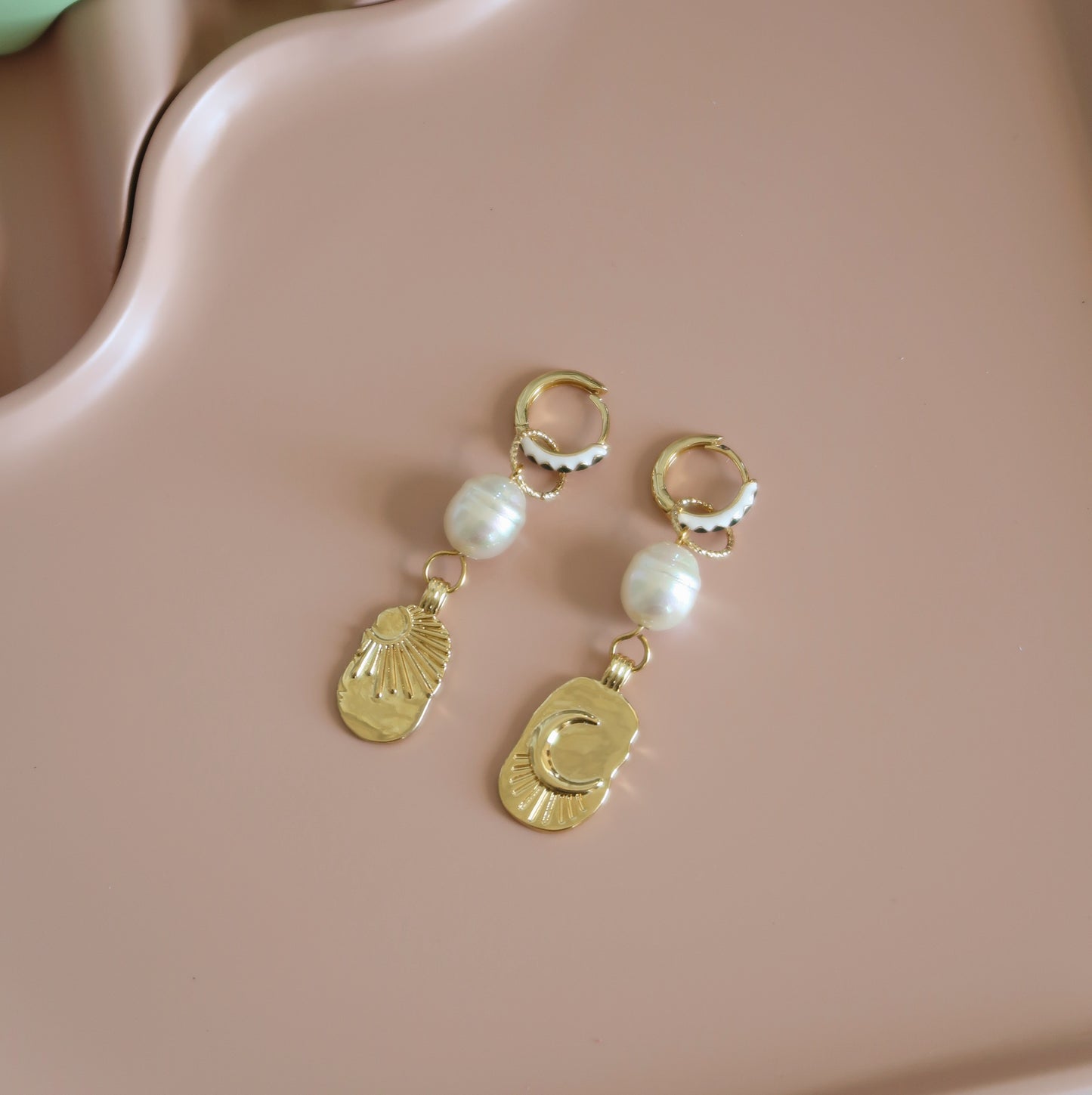 Gold hoop earrings with sun, moon and pearl charms