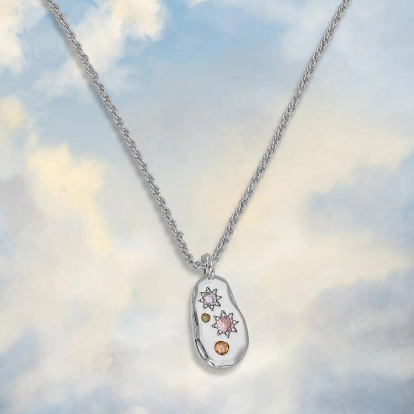 silver pebble style pendant necklace with rope chain and pastel toned cubic zirconia