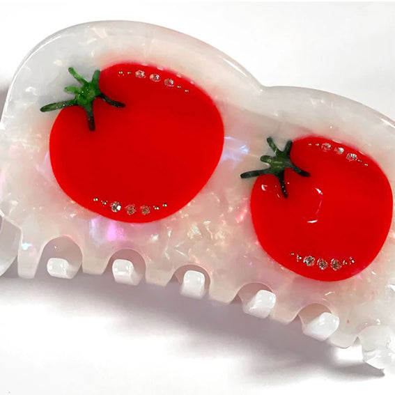 white hair claw with two red tomatoes