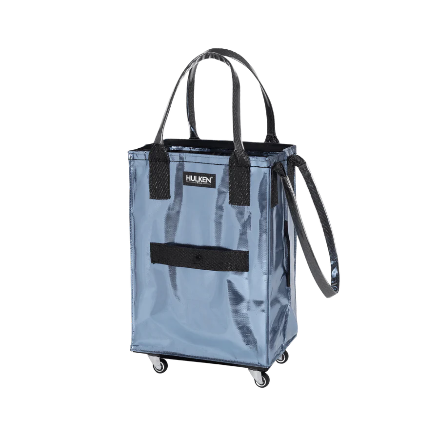 Blue shopping cart bag with black handles and wheels on a white background