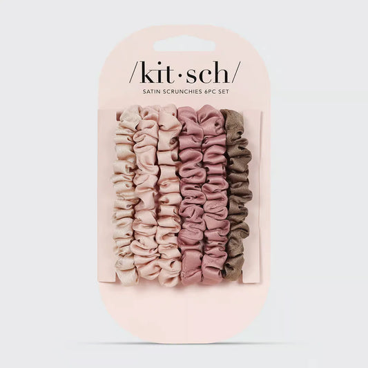 Set of satin scrunchies in pink and beige packaging with 'kit-sch' branding on a light gray background