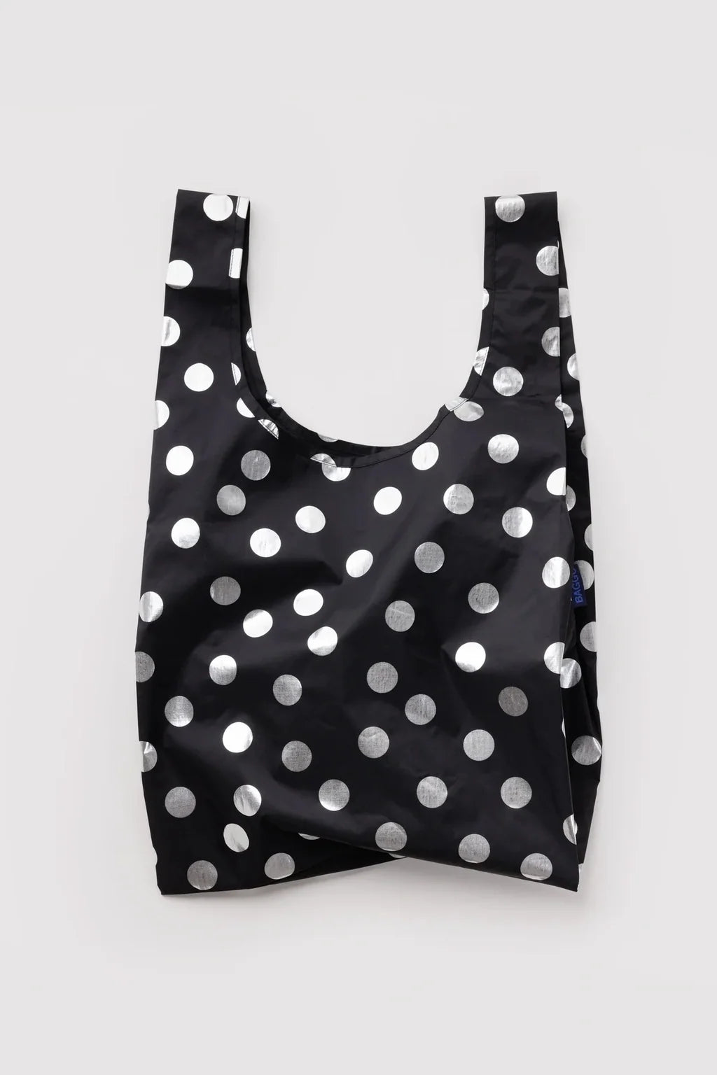 A reusable black nylon shopping bag with a shiny silver polka dot pattern, shown against a plain light gray background.