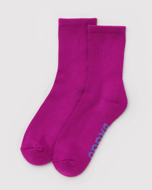Pair of purple socks with a brand logo on a light gray background
