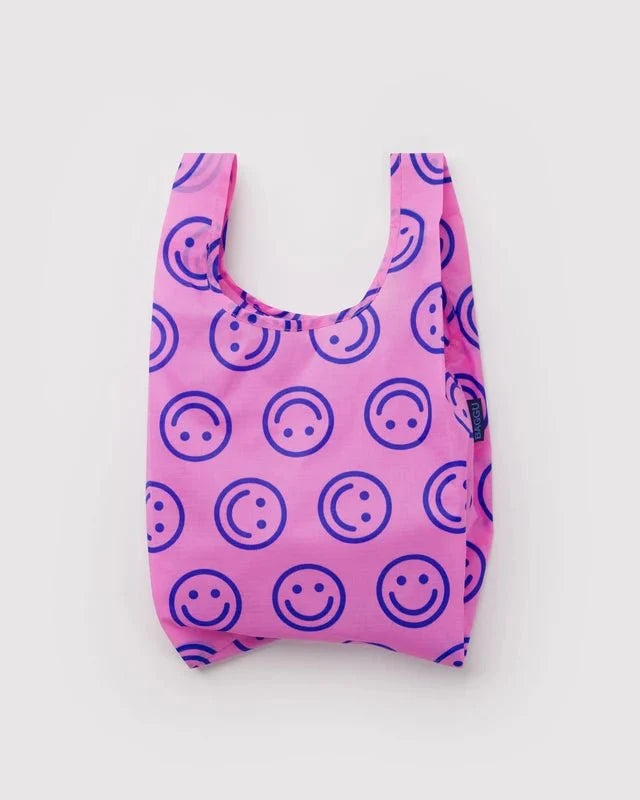 BAGGU Baby Reusable Bag in Pop Pink & Blue Happy Face BAGGU design on a white backgrund 