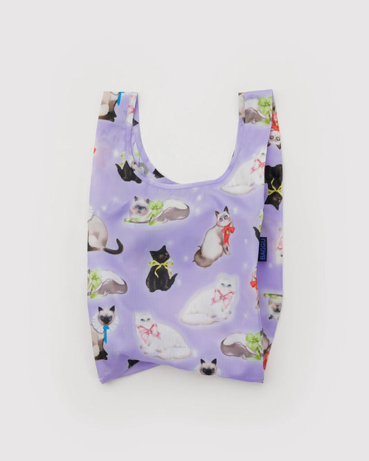 Purple reusable shopping bag with cat pattern on a white background