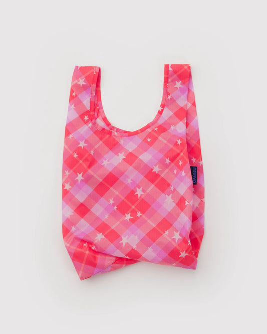 Pink and purple checkered reusable bag on a light gray background