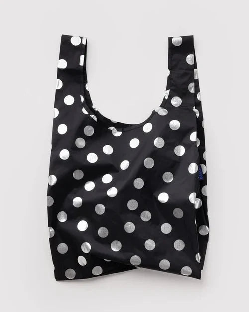 Black reusable bag with white polka dots on a light gray background