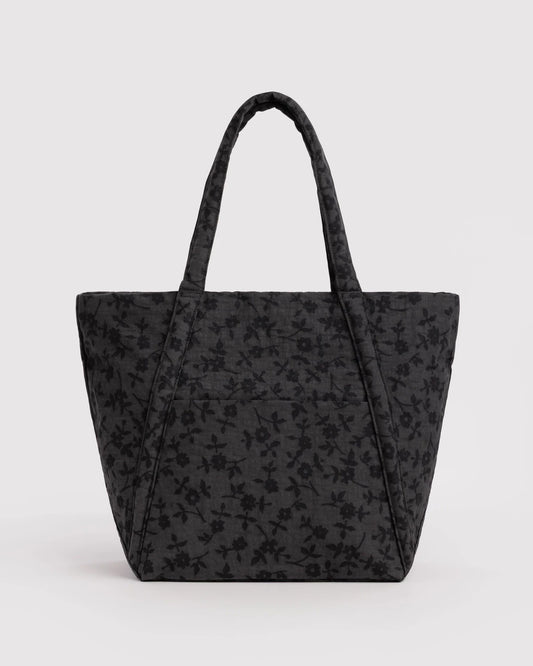 Black floral-patterned tote bag on a light gray background