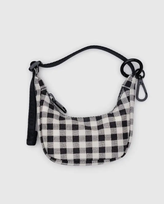 Black and white checkered bag with a strap on a light gray background