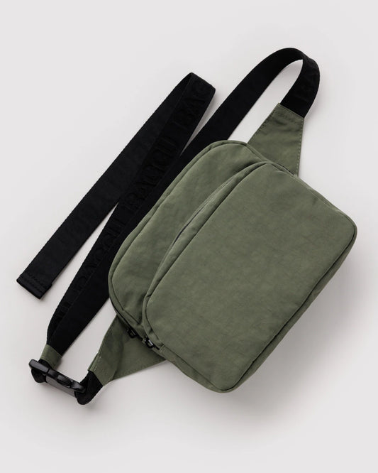 Green waist bag with a black strap on a white background