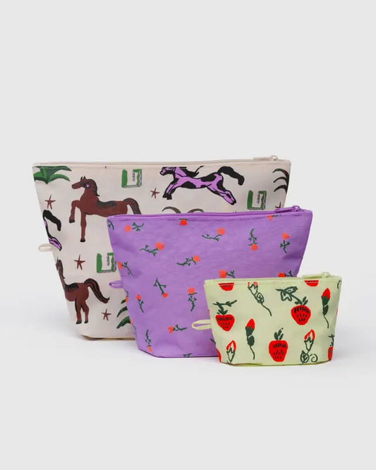 Three fabric pouches with different patterns on a white background