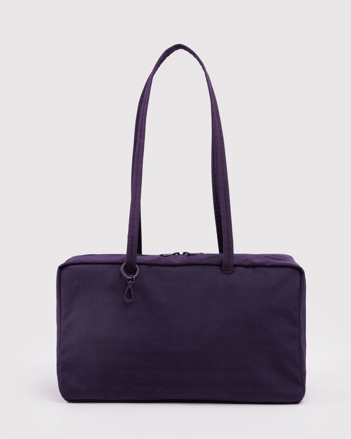 Purple tote bag with a shoulder strap on a light gray background