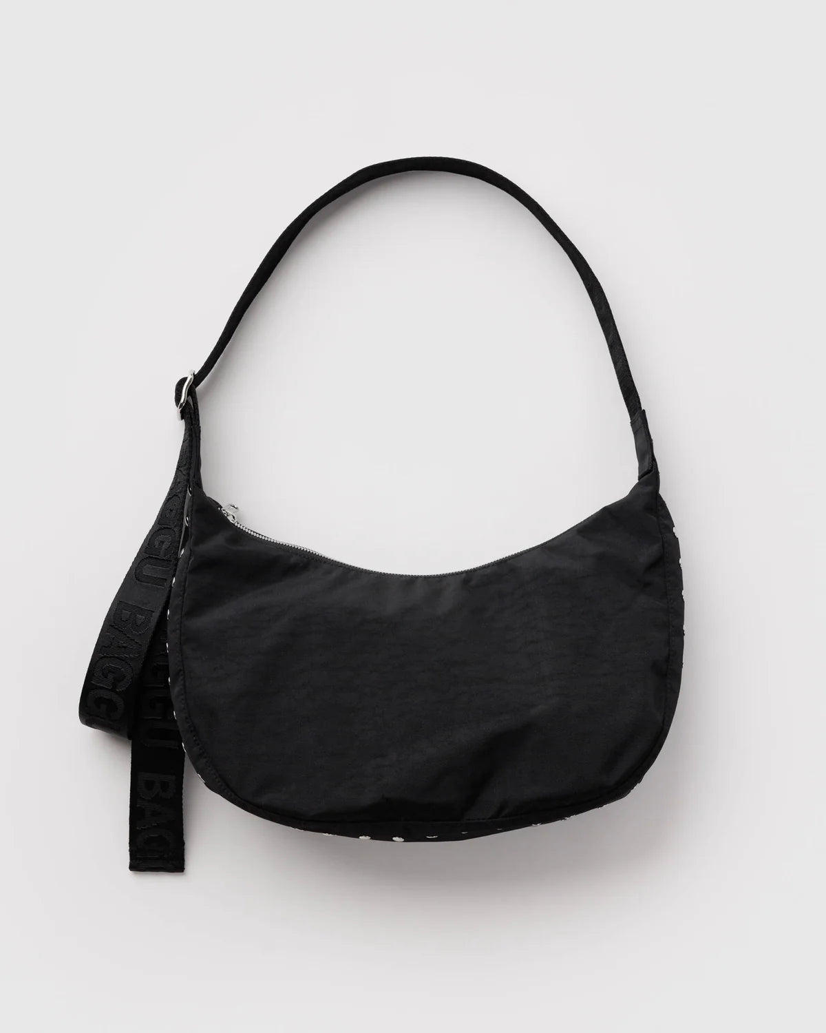 A black crescent-shaped shoulder bag with a wide adjustable strap, shown against a plain light gray background.