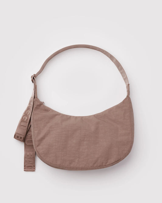 Brown corssbody bag on a light gray background
