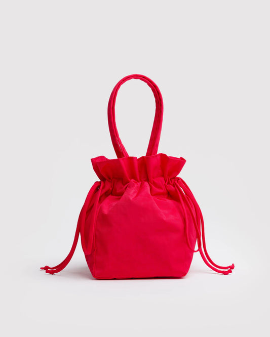 BAGGU Nylon drawstring bag in red colour on white background.