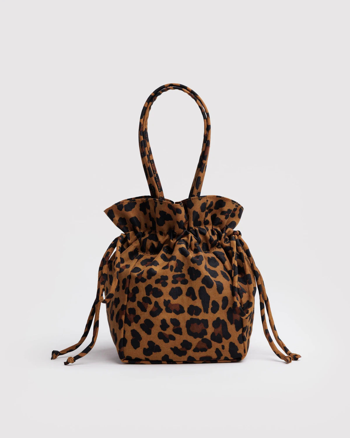 Leopard print drawstring bag on a light gray background
