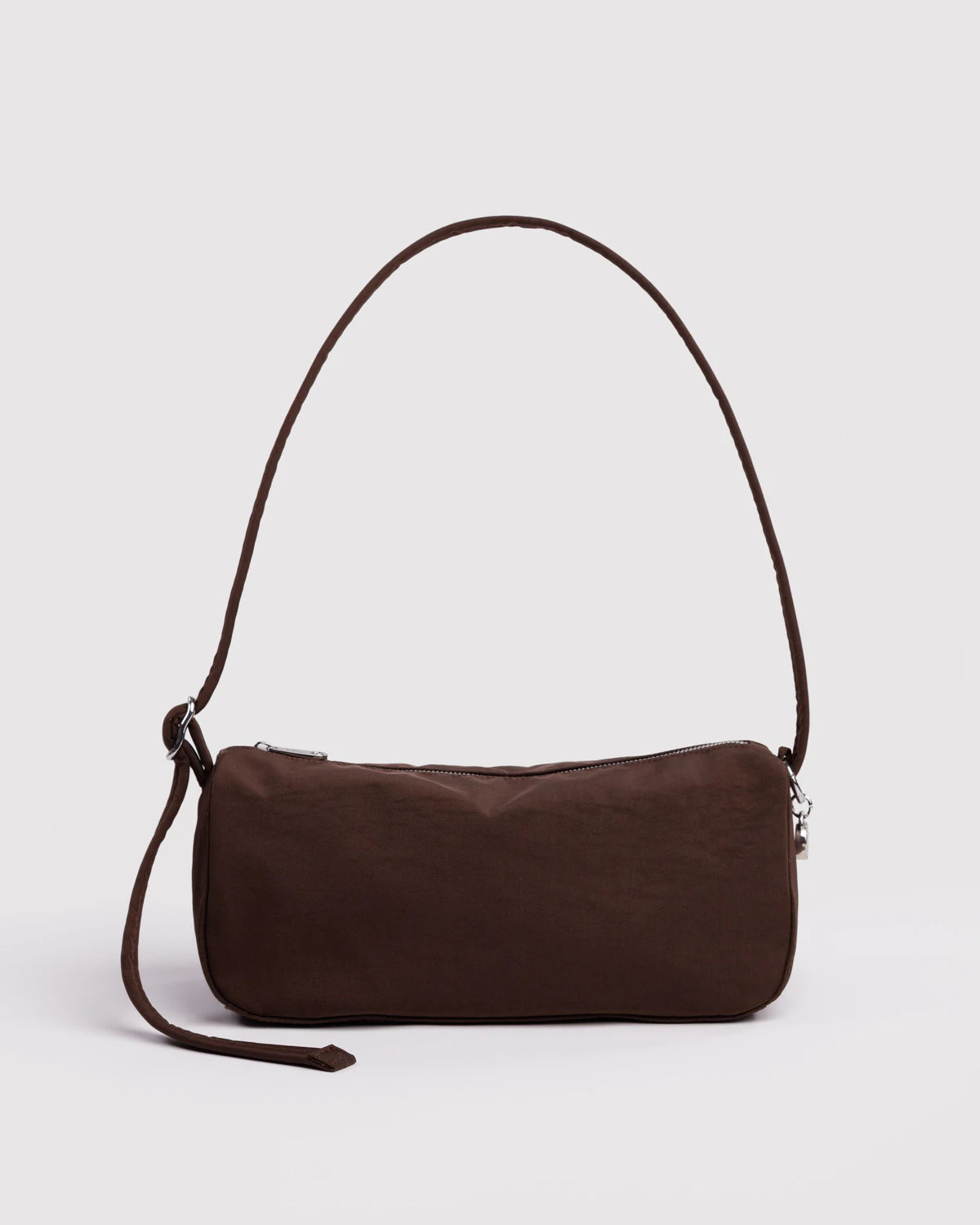 Brown leather handbag with a strap on a light gray background
