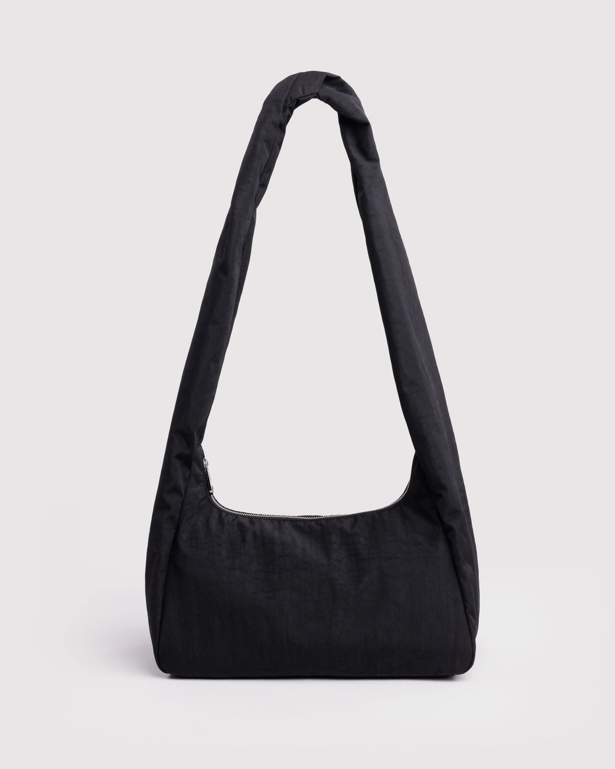 A black slouchy shoulder bag with a single wide strap, photographed against a light gray studio background.