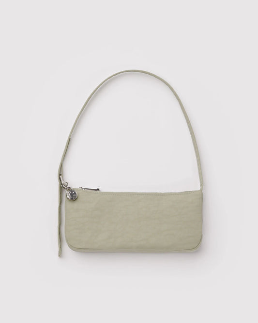 Two-toned handbag with a white top section and beige bottom section on a light gray background