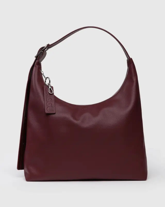 Burgundy handbag with a visible brand tag on a light gray background